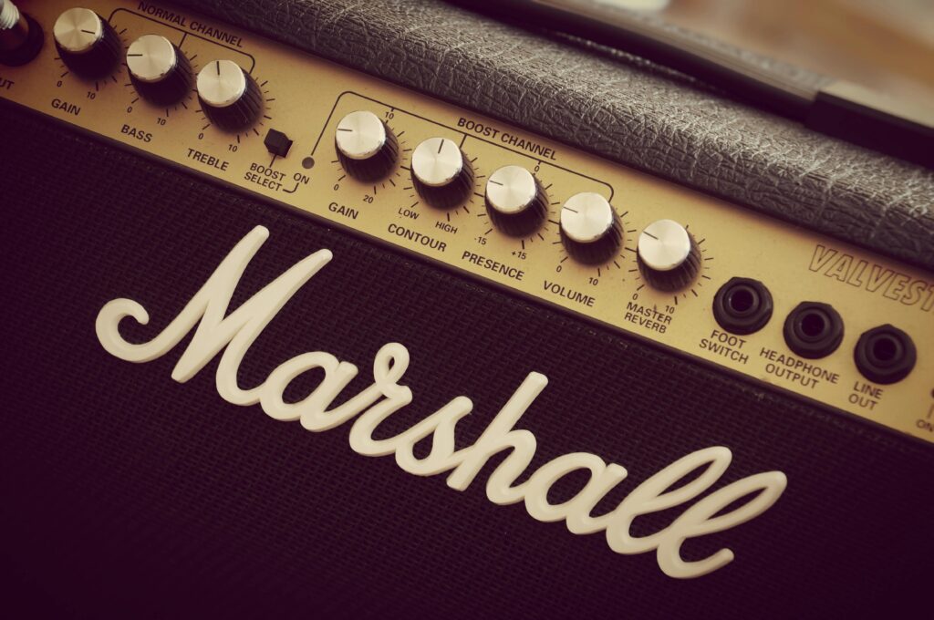 A detailed view of a Marshall amplifier showcasing vintage knobs and branding.
